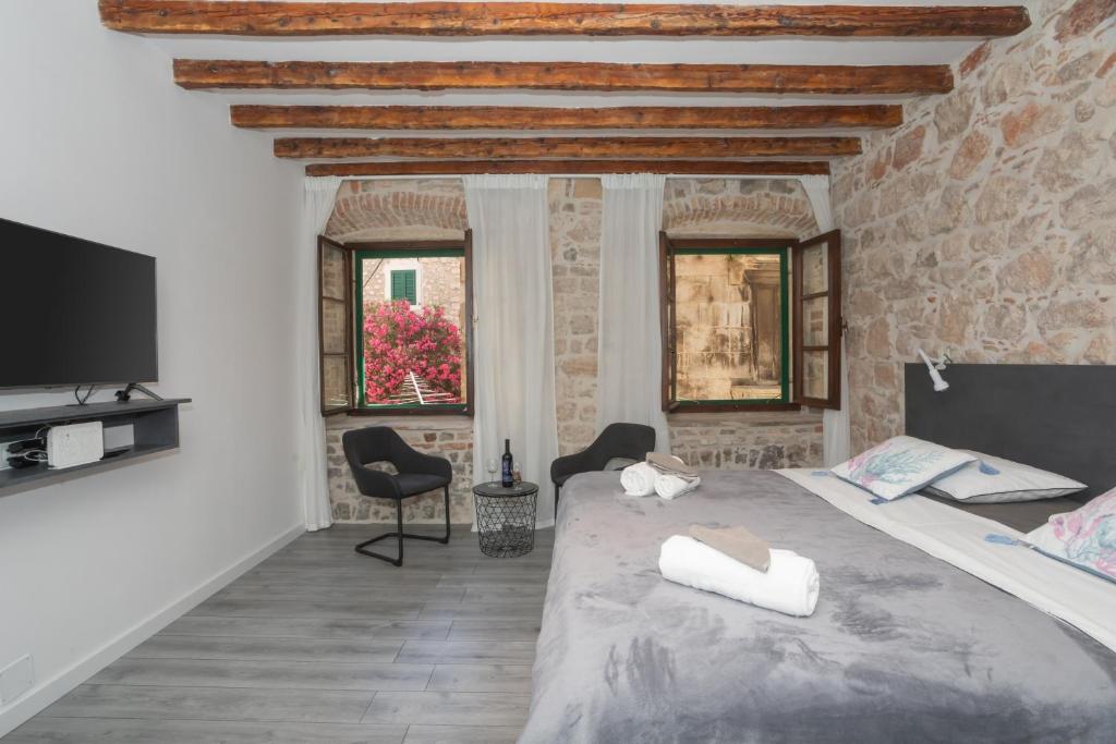 a bedroom with a large bed and a tv at Apartment Libra downtown Šibenik in Šibenik