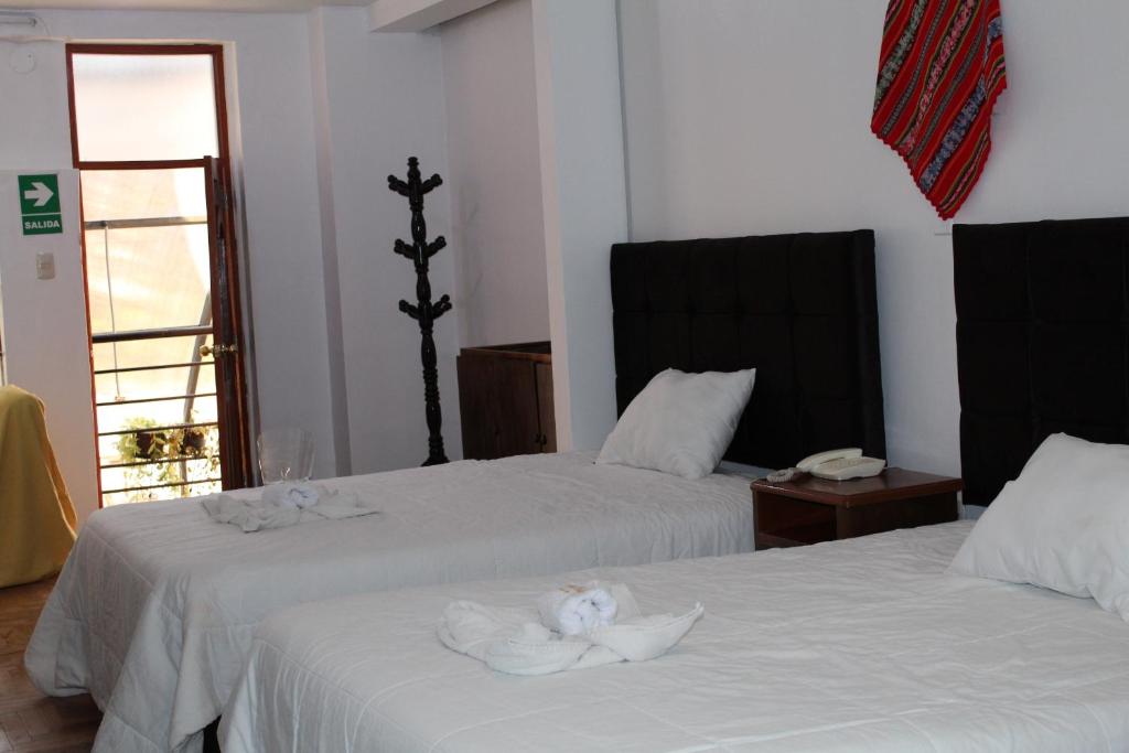 Postel nebo postele na pokoji v ubytování KAARO HOUSE CUSCO