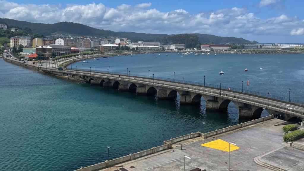 a bridge over a body of water with a city at Golden Views in Viveiro