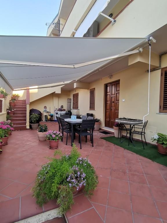 a patio with tables and chairs and plants at Tropea Home Free Private Parking in Tropea