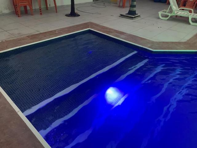 a swimming pool with blue paint on the floor at stellamares apartamentos in Salvador