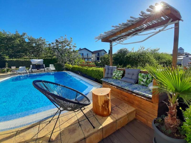 a swimming pool with a chair next to a patio at Milennia Family Hotel in Sunny Beach