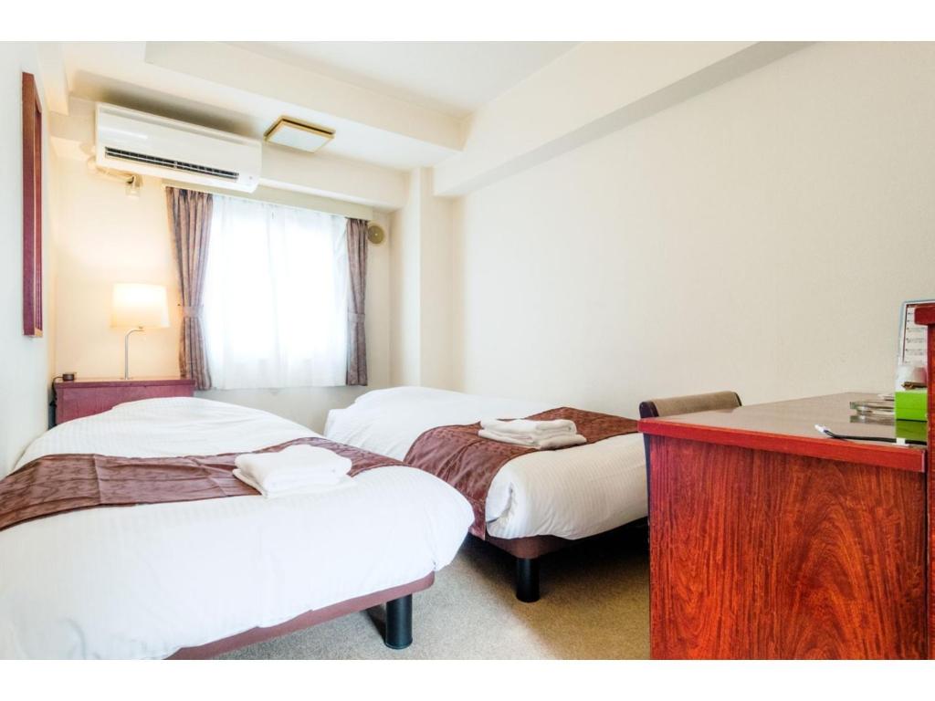 מיטה או מיטות בחדר ב-Sky Heart Hotel Koiwa - Vacation STAY 49103v