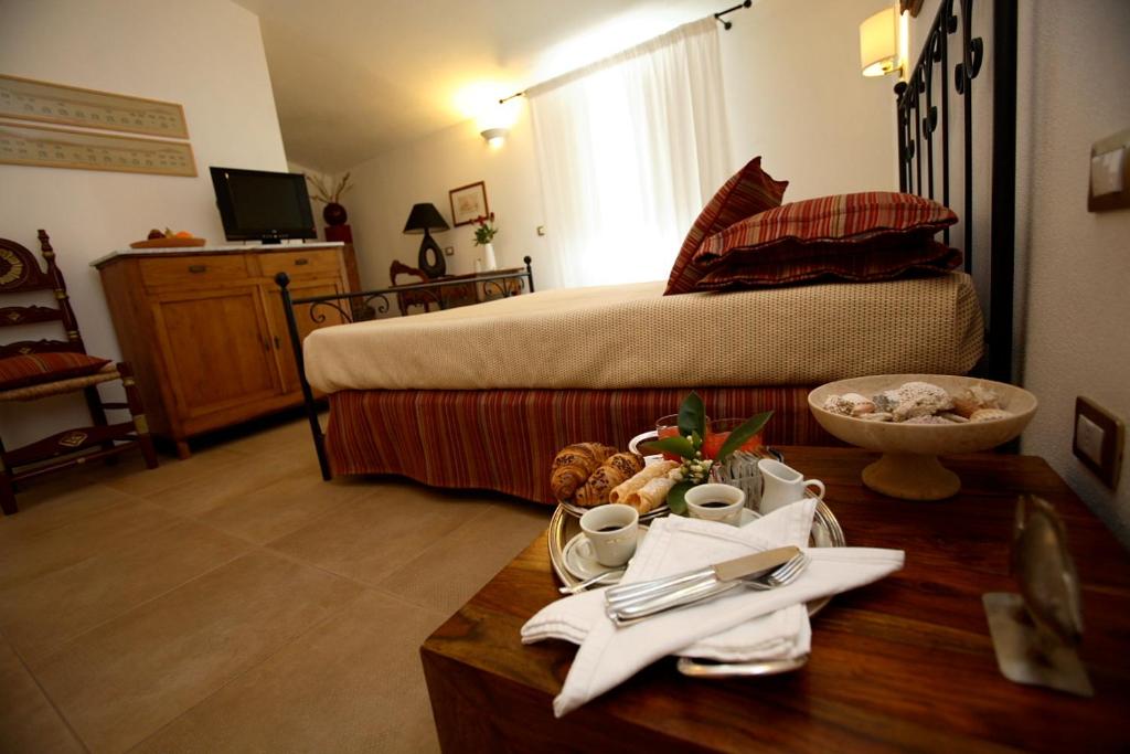 Postel nebo postele na pokoji v ubytování Hotel Villa Pimpina