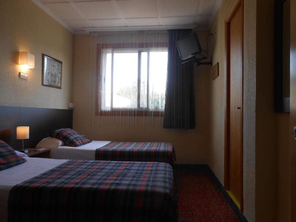 Postel nebo postele na pokoji v ubytování Hostal El Callejón