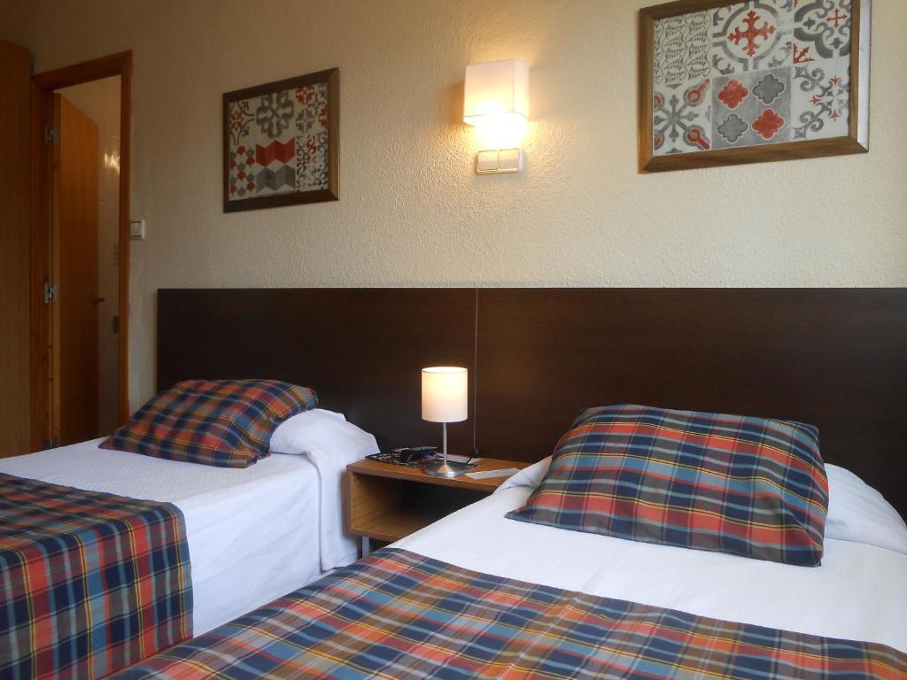 Postel nebo postele na pokoji v ubytování Hostal El Callejón