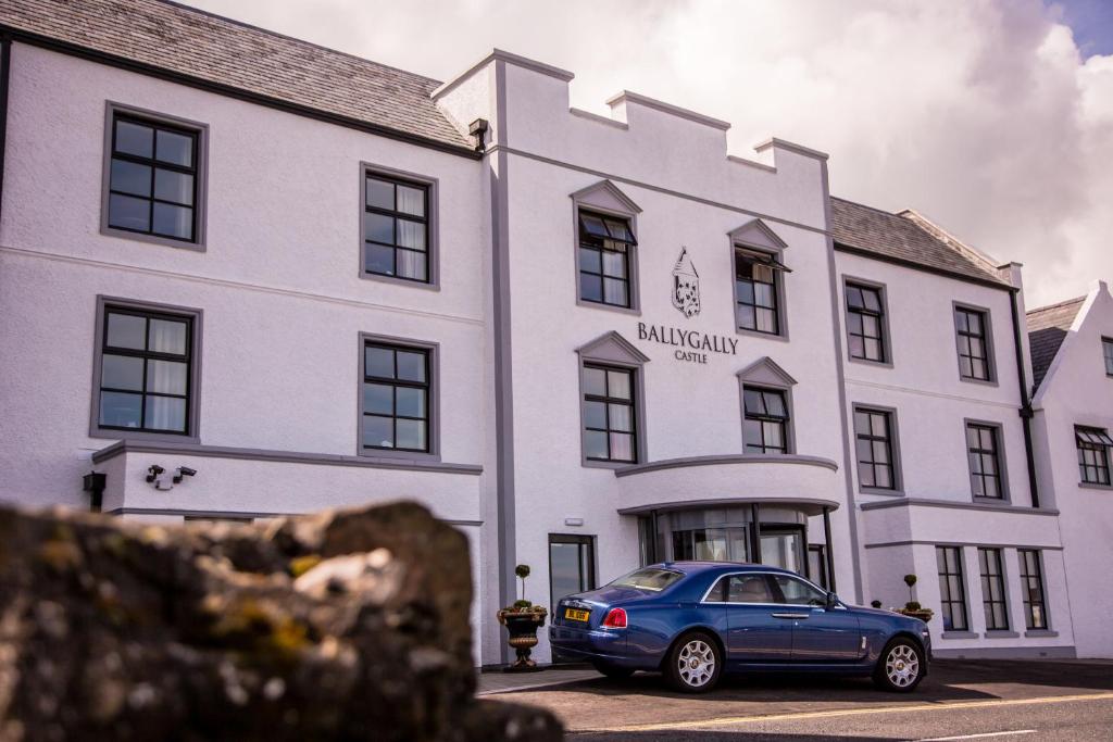 a blue car parked in front of a white building at Ballygally Castle in Larne
