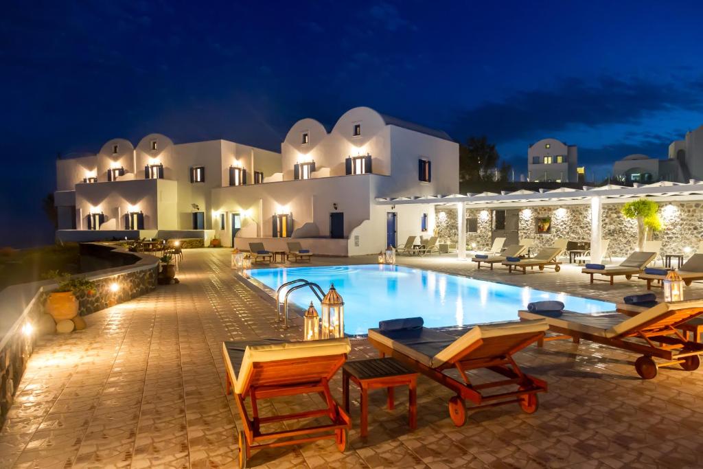 a villa with a swimming pool at night at Sigal Villa in Akrotiri