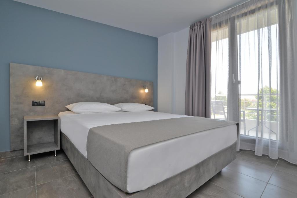 Postel nebo postele na pokoji v ubytování MAK Apartments