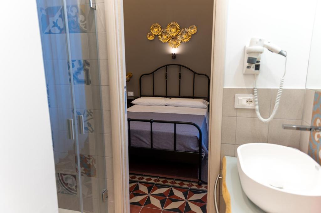 a bathroom with a shower and a toilet and a sink at Ursino's Luxury in Catania
