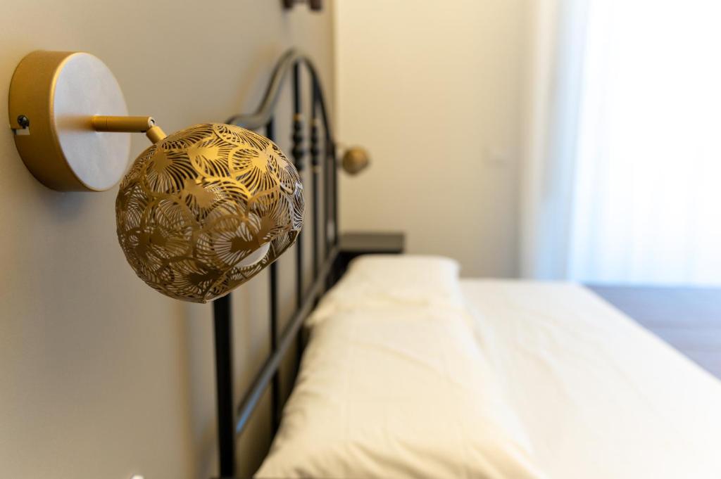 a room with a bed with a metal head board at Ursino's Luxury in Catania
