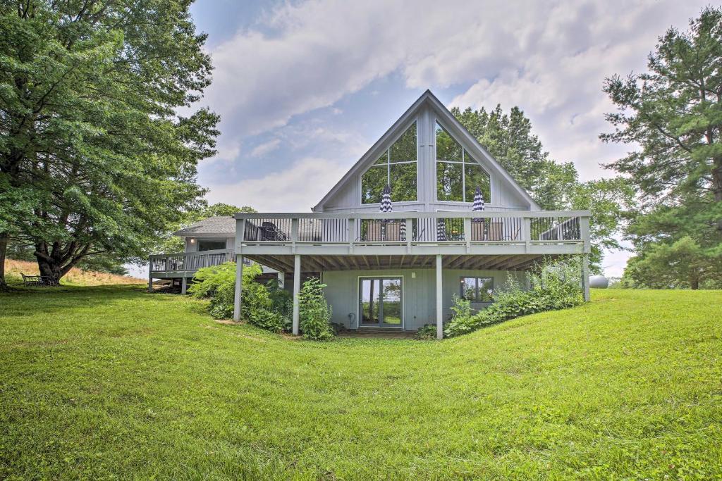 a large house with a deck on a lawn at Lake Cumberland Home with Deck and Water Access! in Monticello
