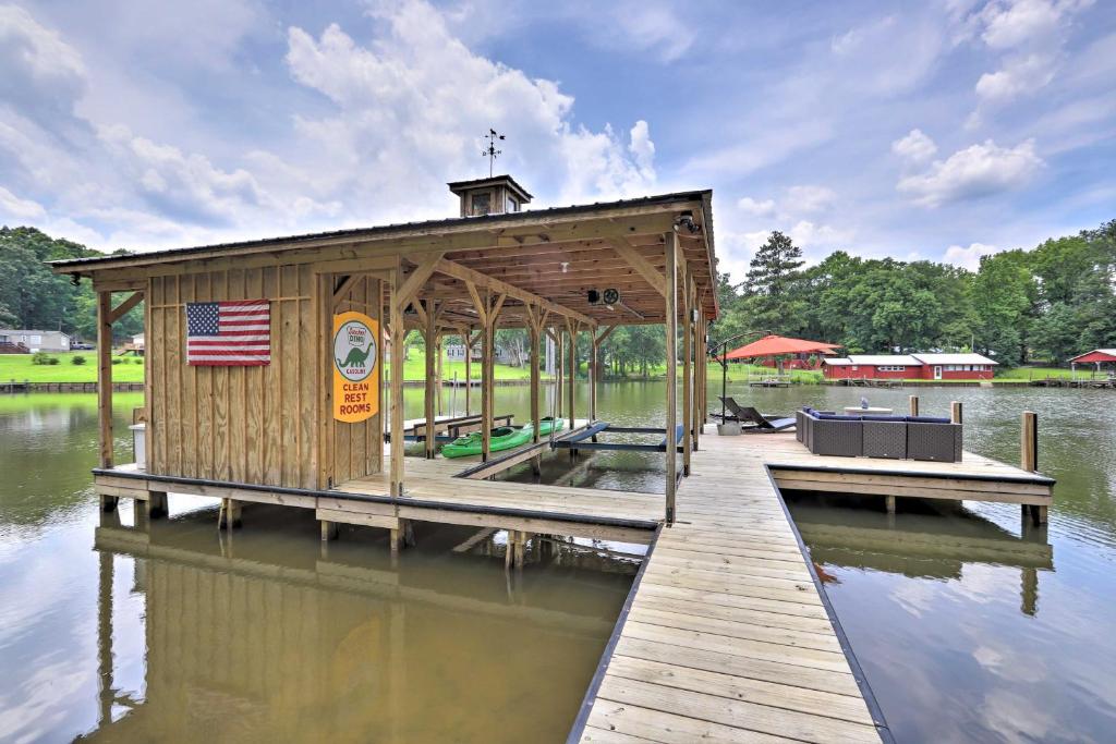 a small building on a dock on a body of water at Lake Sinclair House with Lake Access and Kayaks! in Milledgeville