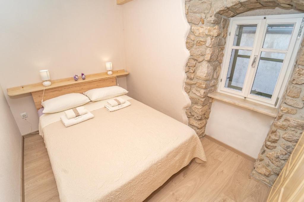 Postel nebo postele na pokoji v ubytování Apartman Nono Tone