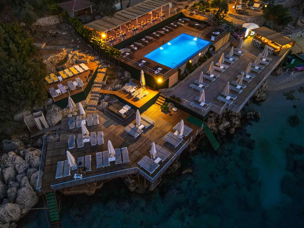 an aerial view of a resort with a swimming pool at GREENBEACH HOTEL in Kalkan
