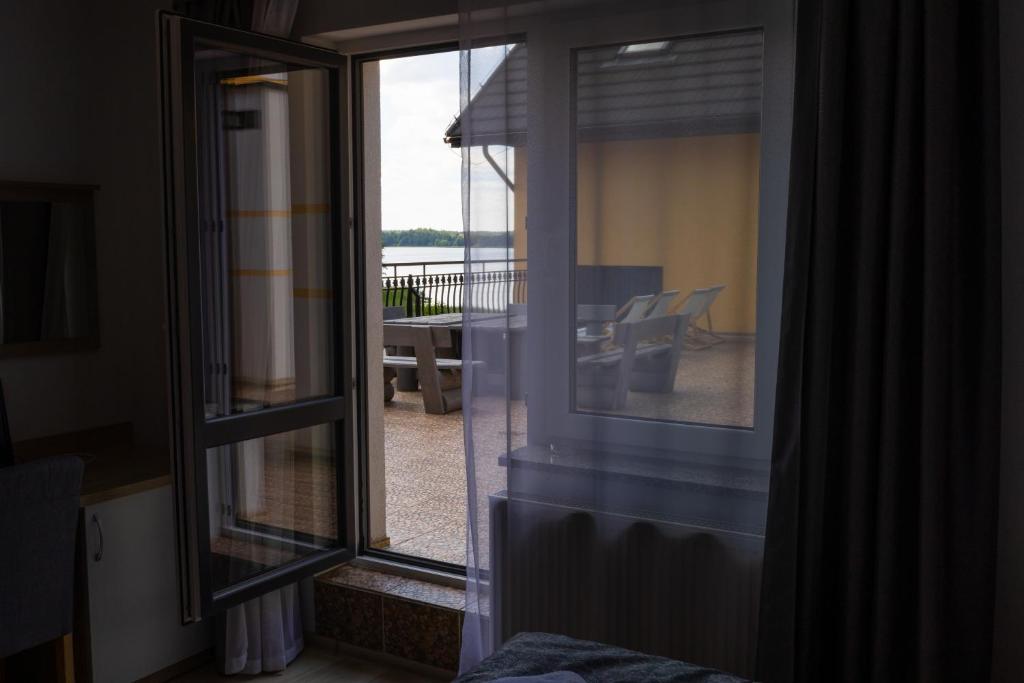 View from room window showing patio and distant lake.