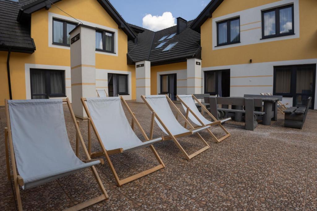 Outdoor patio with several deck chairs and seating area.