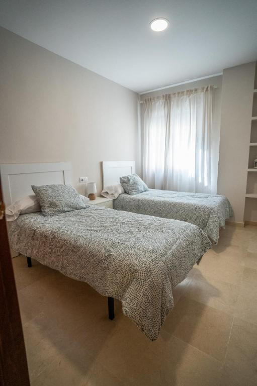 Postel nebo postele na pokoji v ubytování Las Palomas 15