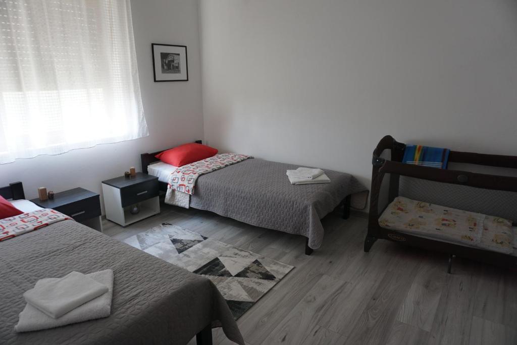 Postel nebo postele na pokoji v ubytování Apartman Santos