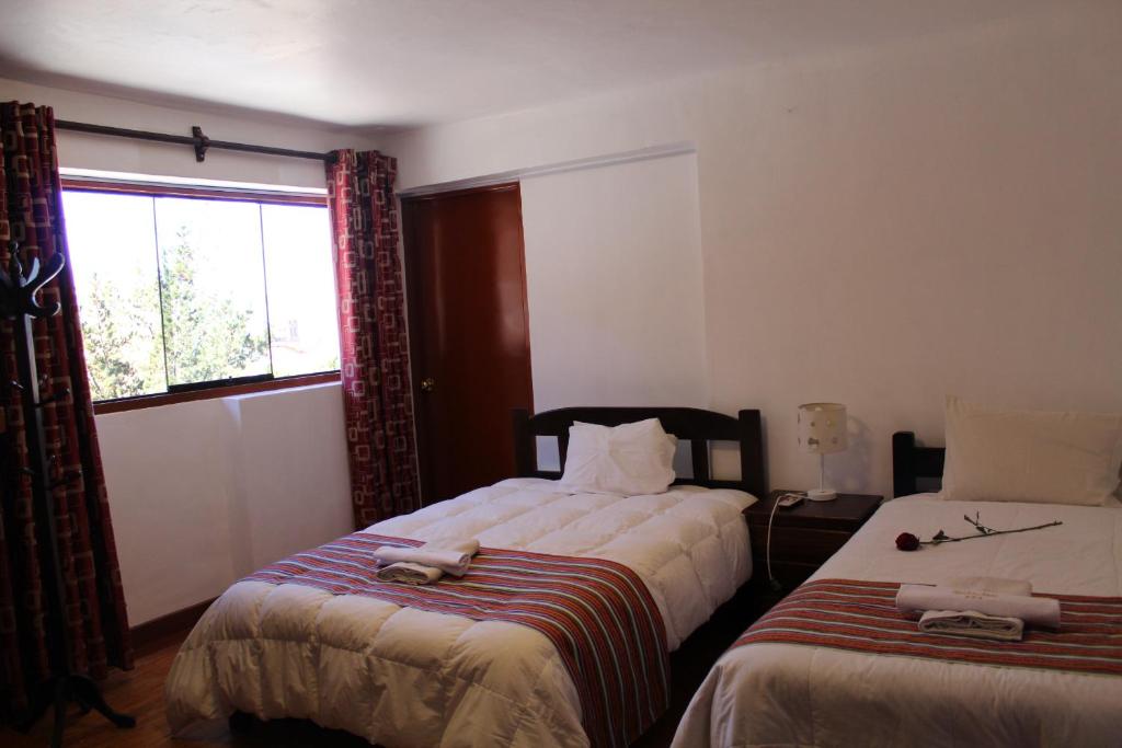 Postel nebo postele na pokoji v ubytování KAARO HOUSE CUSCO