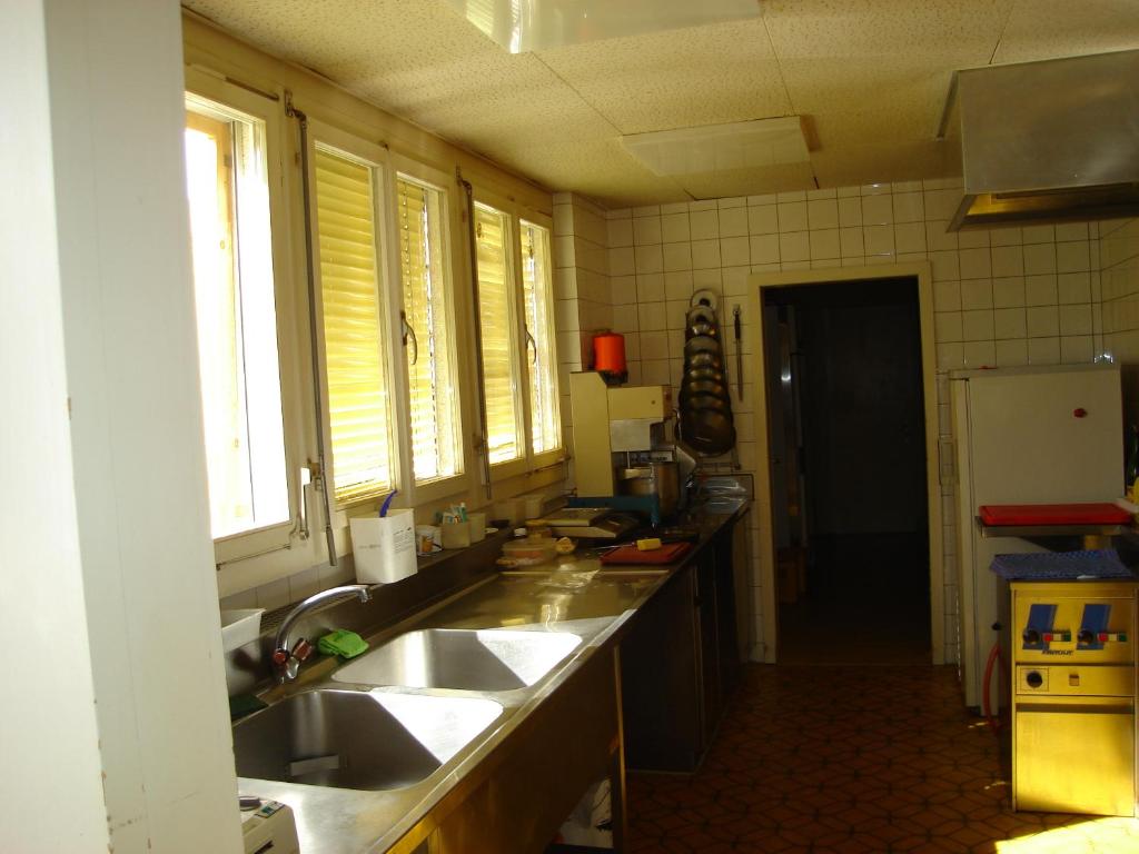 Kuchyň nebo kuchyňský kout v ubytování Hotel Milan B&B