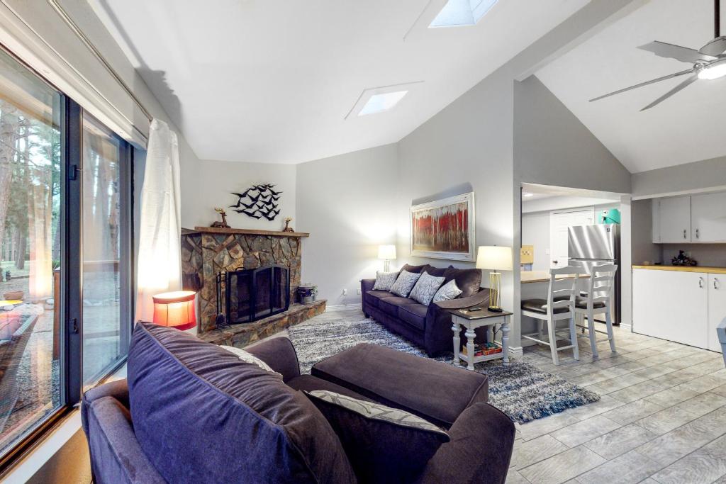 a living room with a couch and a table at Cozy Mountain Townhome in Flagstaff