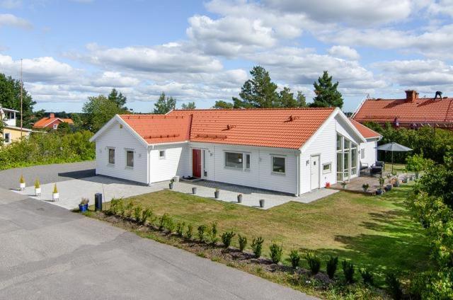 a small white house with an orange roof at Great Stay Villa Sandviken in Sandviken