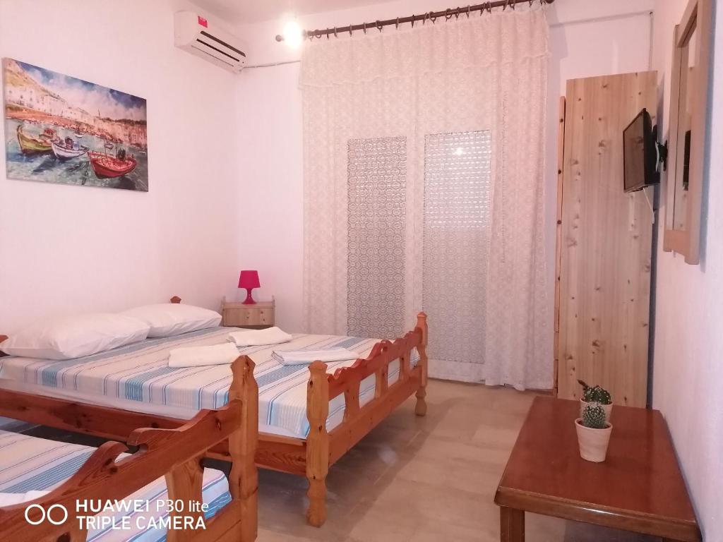 Postel nebo postele na pokoji v ubytování Velikis Apartments