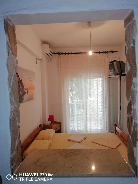 Postel nebo postele na pokoji v ubytování Velikis Apartments