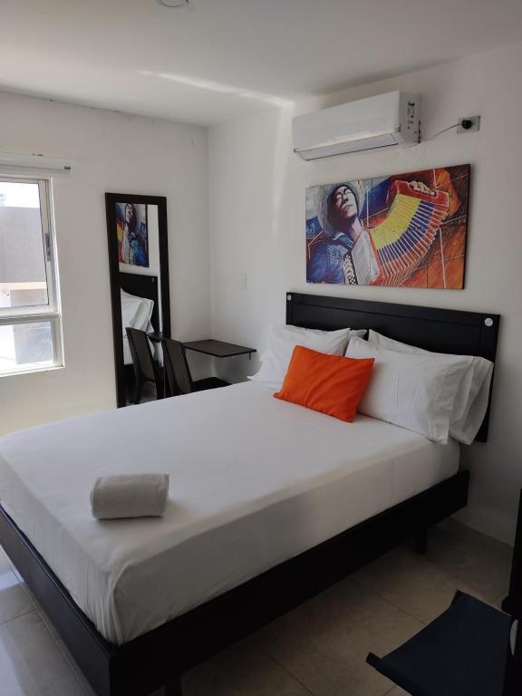 Postel nebo postele na pokoji v ubytování HOTEL ESCALA GC Valledupar