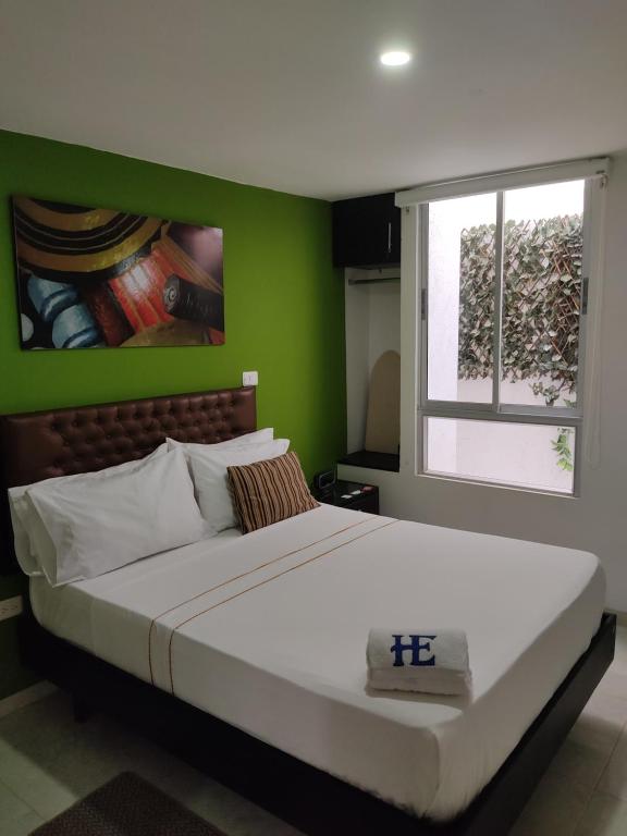 Postel nebo postele na pokoji v ubytování HOTEL ESCALA GC Valledupar