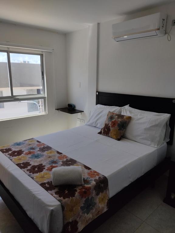 Postel nebo postele na pokoji v ubytování HOTEL ESCALA GC Valledupar