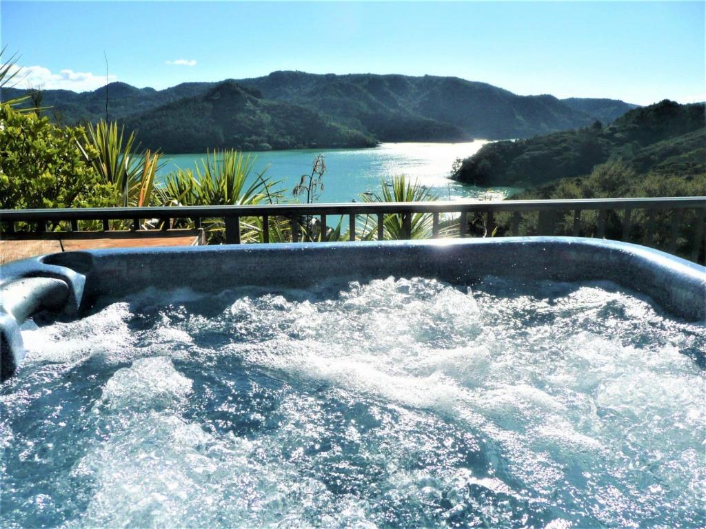 a hot tub with a view of a river at King's View Lodge in Whangaroa