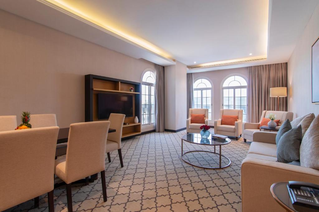 a living room with a couch and a table at Gardino Hotel & Residence in Riyadh