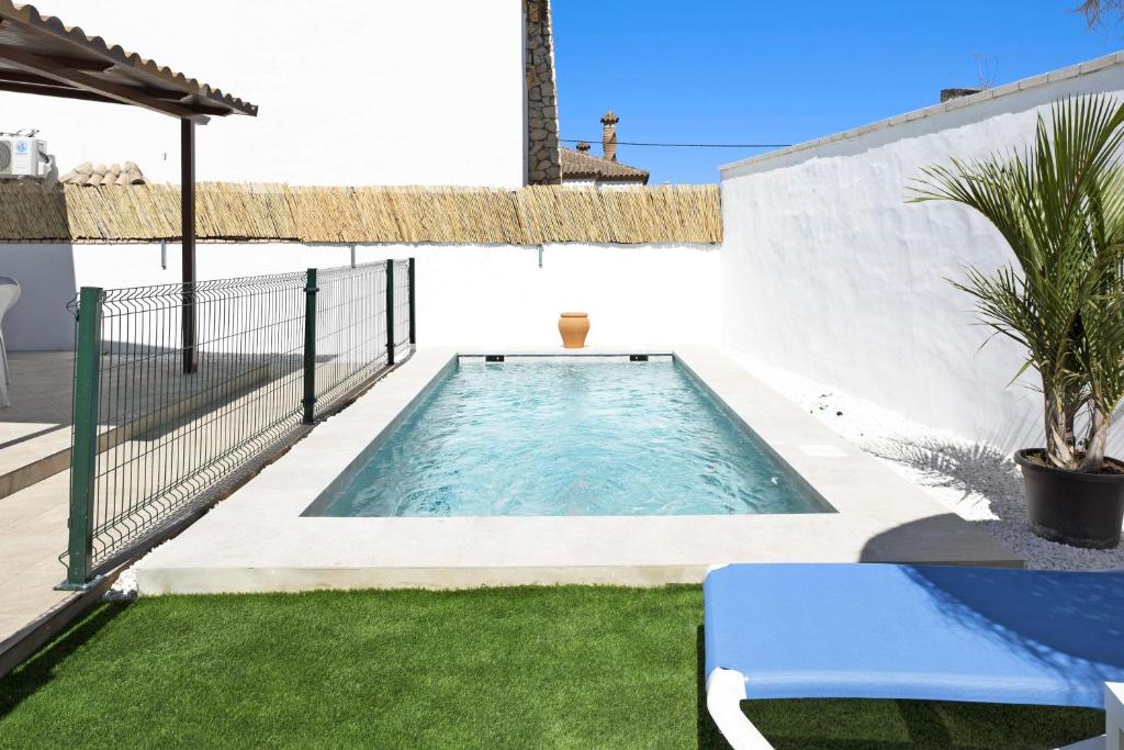 a swimming pool in the backyard of a house at Casa Jaime in Conil de la Frontera