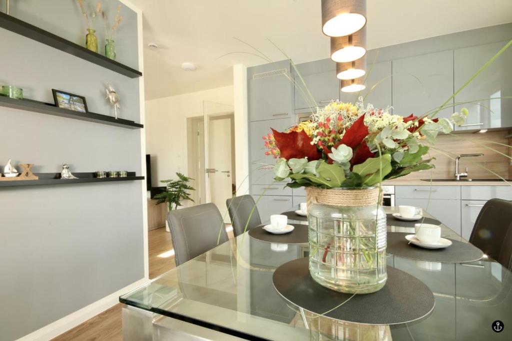 a vase of flowers on a glass table in a kitchen at Haus Sonnendeck - Sonnenweg 21 in Heringhausen