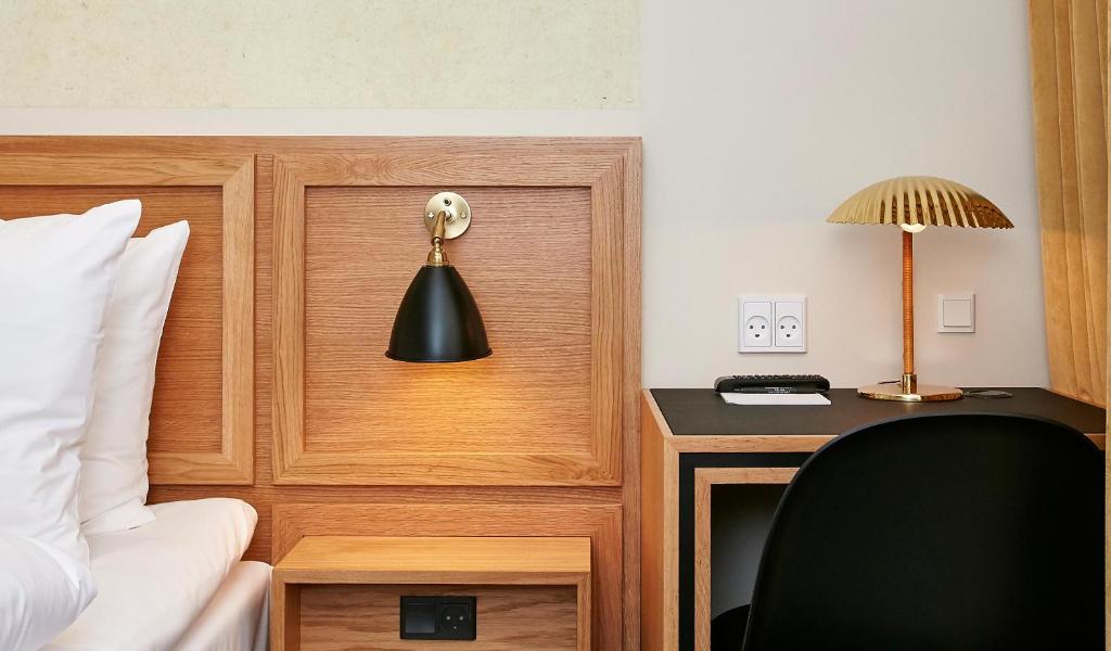 Postel nebo postele na pokoji v ubytování Jørgensens Hotel