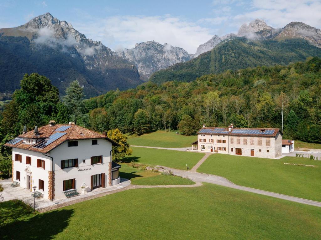 an aerial view of a house with mountains in the background at Fondazione Lucia De Conz 