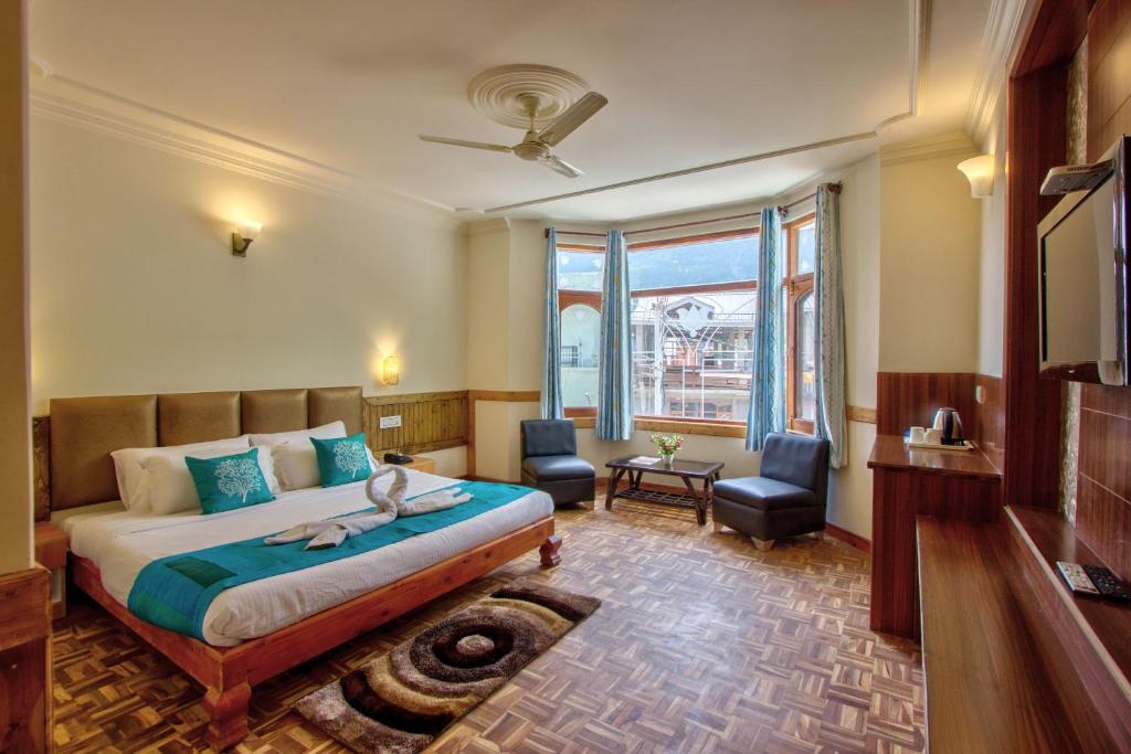 Postel nebo postele na pokoji v ubytování Woodstock Inn Manali