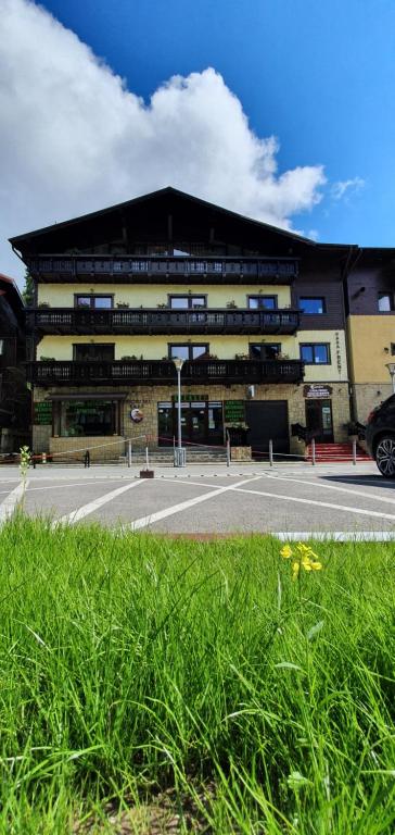 a building with a parking lot in front of it at Casa Frent in Predeal