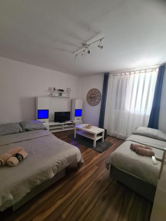 a bedroom with two beds and a television in it at Apartment Dada in Pula