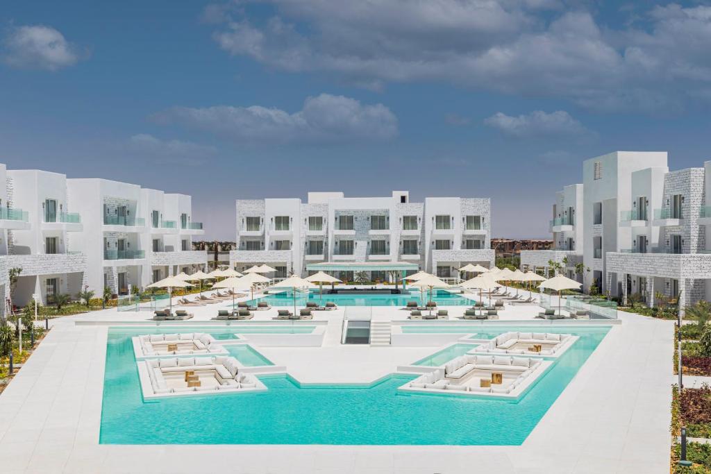 an aerial view of a resort with a pool and umbrellas at Tanoak Resort in Ain Sokhna