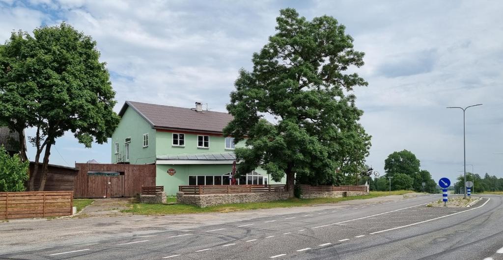 uma casa verde ao lado de uma estrada em Kresto em Mäo