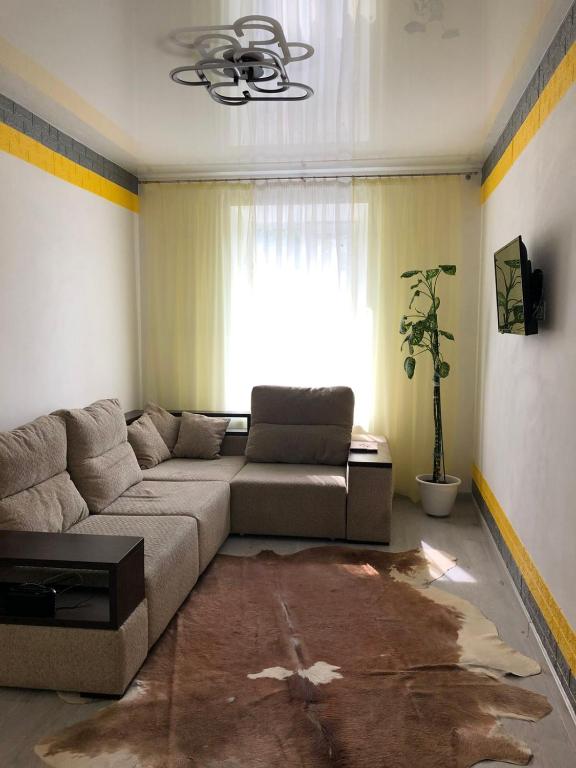 a living room with a couch and a window at Devolano 1 in Odesa