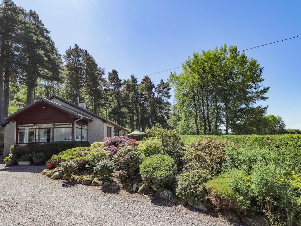 a house with a garden in front of it at Culreach Lodge in Grantown on Spey