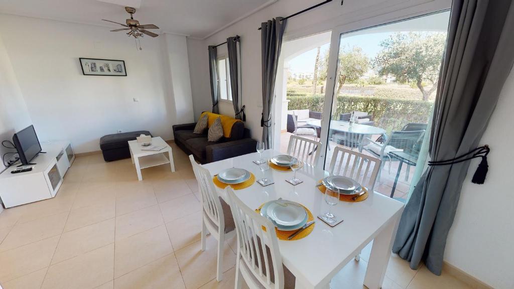 - une table et des chaises blanches dans le salon dans l'établissement Casa Indico RP-Murcia Holiday Rentals Property, à Sucina