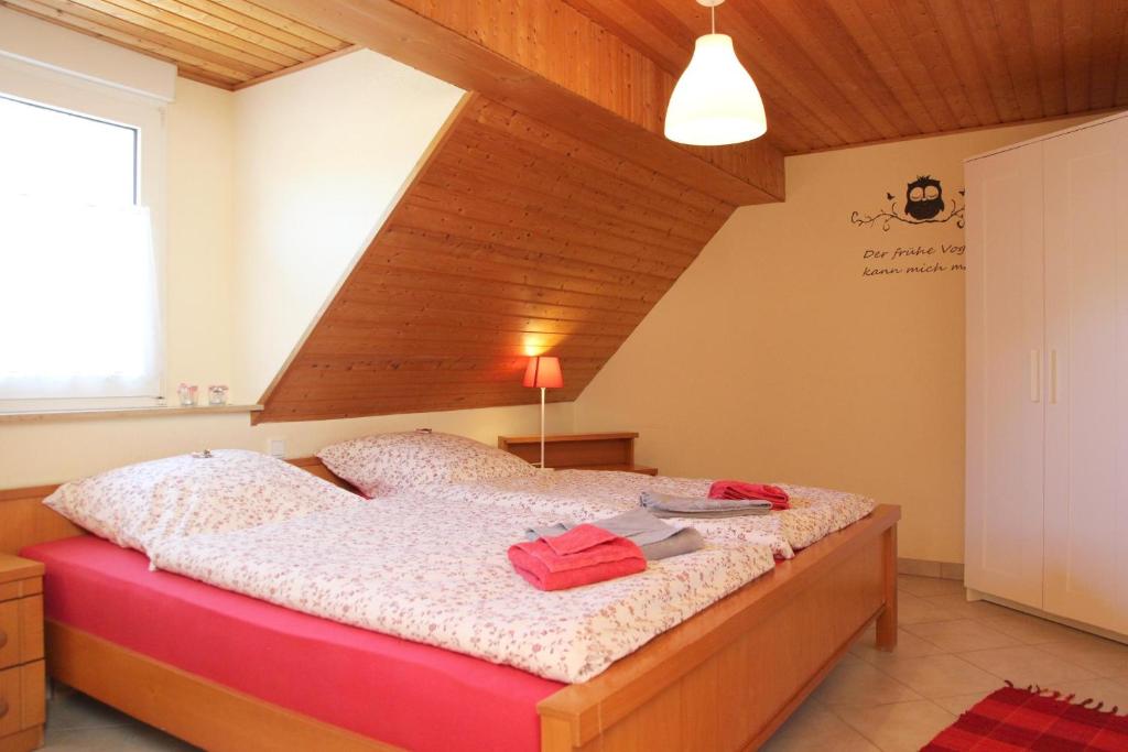 a bedroom with a large bed with a wooden ceiling at Ferienwohnung Greetje in Olsberg