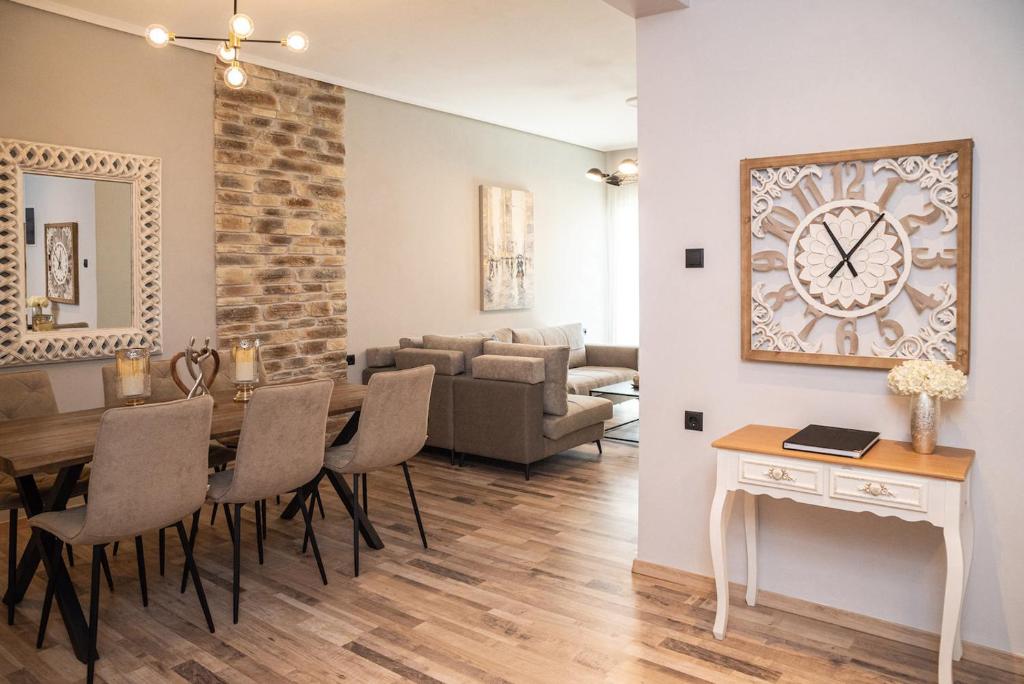 una sala da pranzo e un soggiorno con tavolo e sedie. di Charissa apartment a Volos