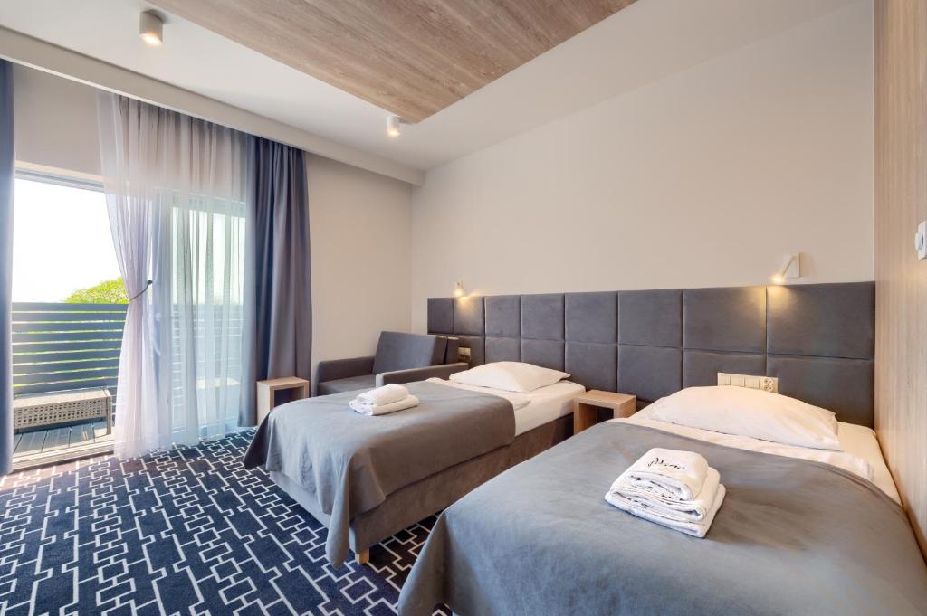 Postel nebo postele na pokoji v ubytování Hotel Wena