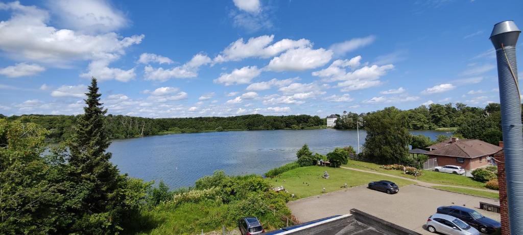 an aerial view of a river with a house and a lake at Lake Views in Gråsten